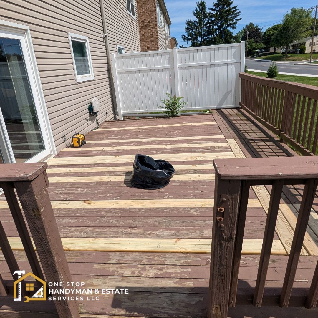 deck repair A brown wooden deck that was repaired in various spots on the floor.